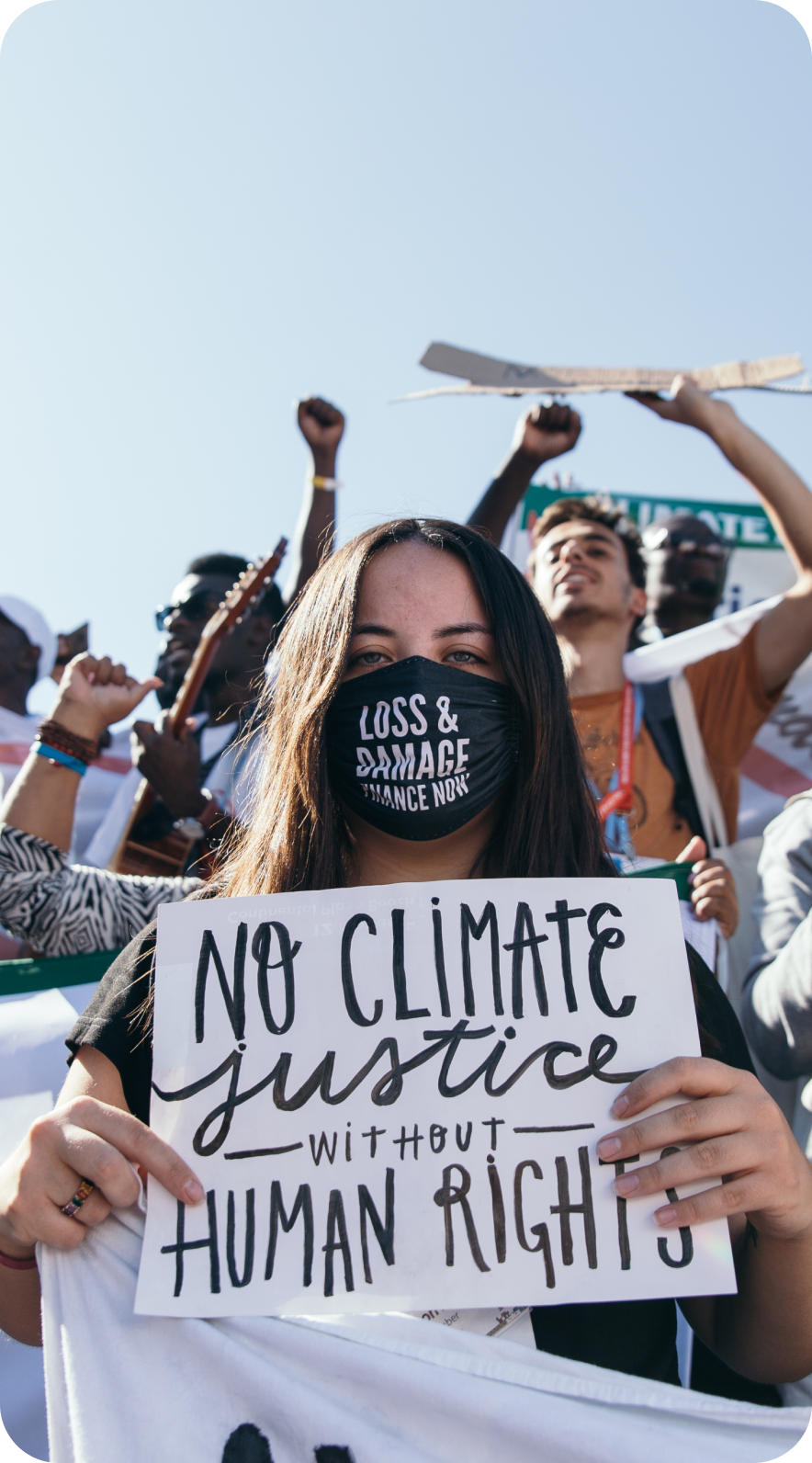 Climate activist holding 'NO CLIMATE justice WITHOUT HUMAN RIGHTS' sign