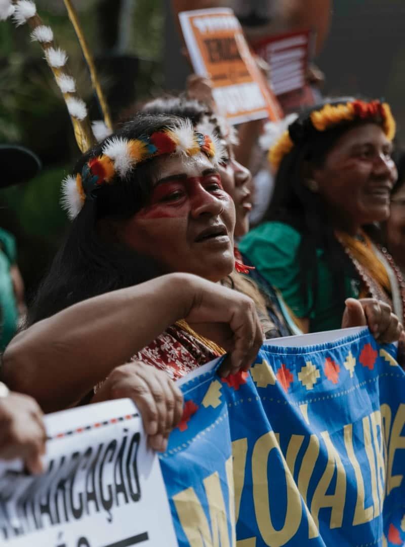 Climate activist holding 'NO CLIMATE justice WITHOUT HUMAN RIGHTS' sign